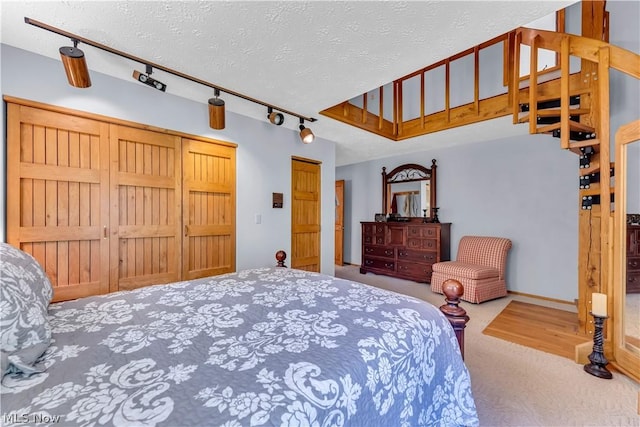 bedroom featuring a textured ceiling and carpet