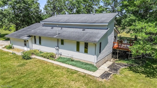 view of front of house featuring a deck and a front lawn