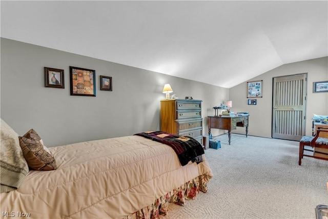 carpeted bedroom featuring lofted ceiling