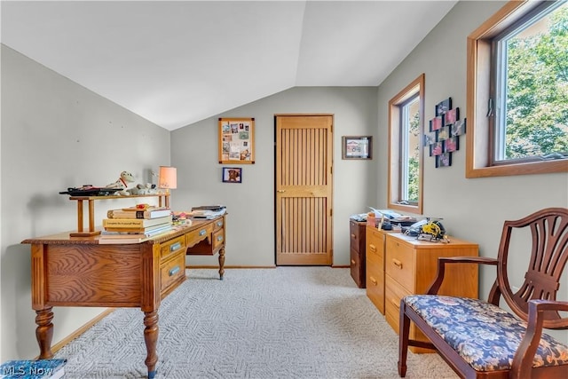 carpeted office featuring lofted ceiling