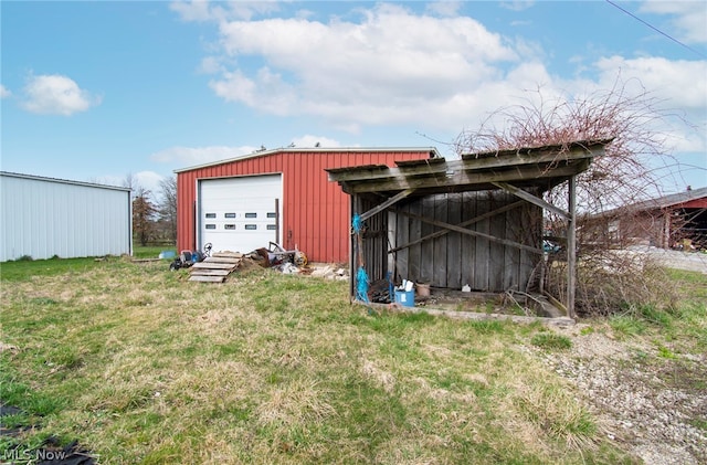 view of outbuilding featuring a garage and a lawn