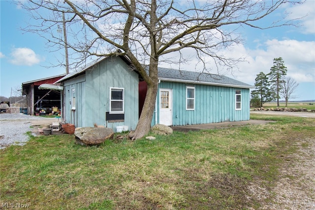 view of outbuilding featuring a lawn