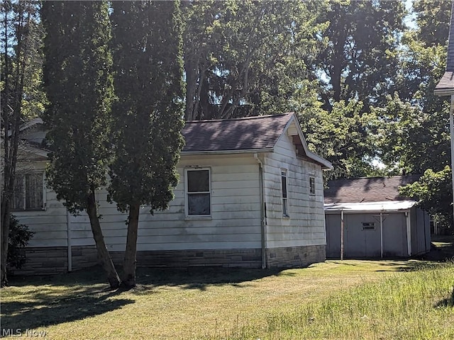 view of side of home featuring a yard