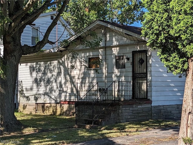 view of side of home with a lawn