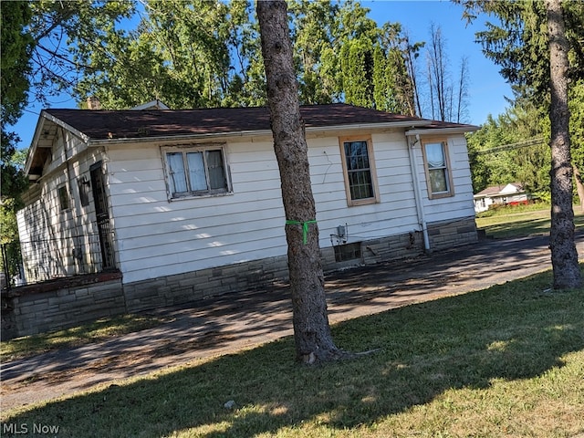 view of home's exterior with a lawn