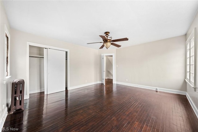 unfurnished bedroom with radiator, dark hardwood / wood-style flooring, and ceiling fan