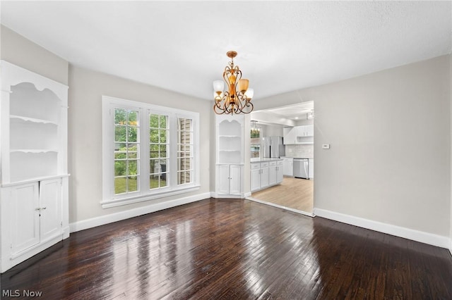 unfurnished dining area with hardwood / wood-style flooring and a notable chandelier