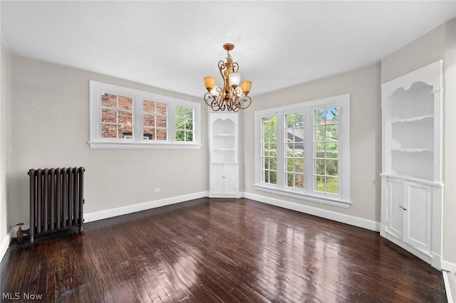 unfurnished dining area featuring radiator, a chandelier, and dark wood-type flooring