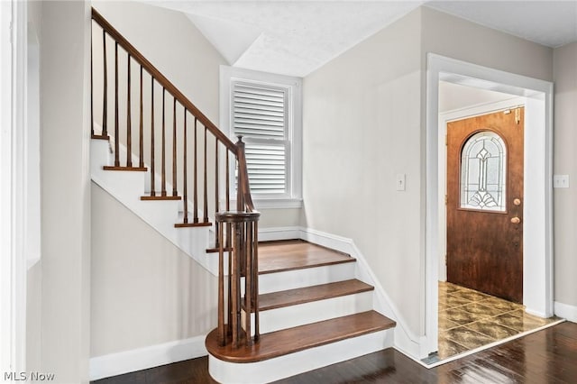 entryway with dark hardwood / wood-style floors