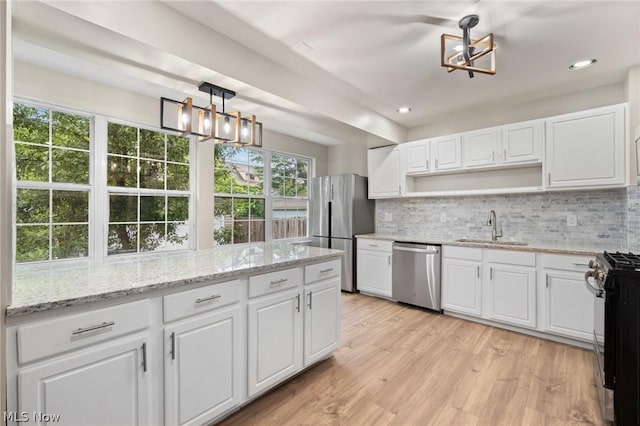 kitchen with white cabinets, appliances with stainless steel finishes, and sink