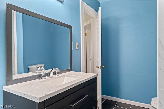 bathroom featuring toilet, tile patterned floors, and vanity