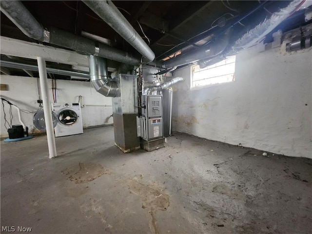 basement with washer / dryer and heating unit