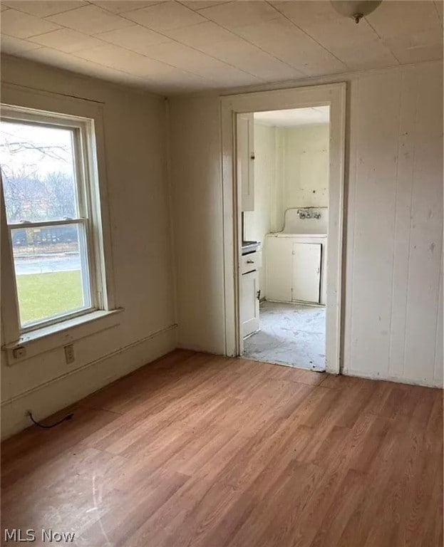 spare room with sink and light hardwood / wood-style flooring