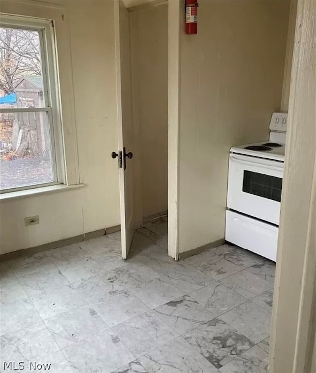 kitchen with tile patterned flooring and electric range