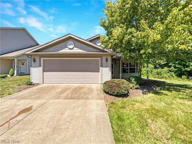 view of front of home featuring a garage and a front lawn