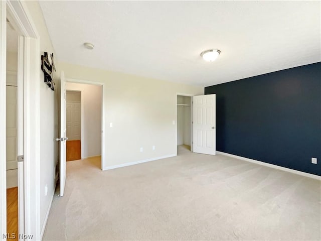 unfurnished bedroom featuring light carpet