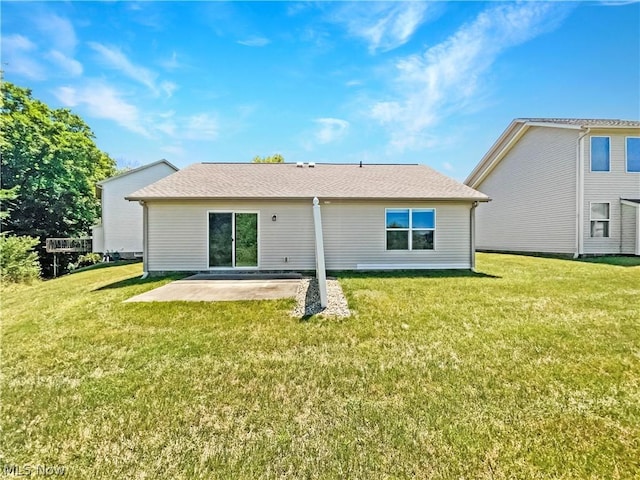 back of property featuring a patio area and a lawn