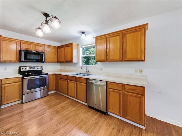 kitchen featuring sink, light hardwood / wood-style flooring, and appliances with stainless steel finishes