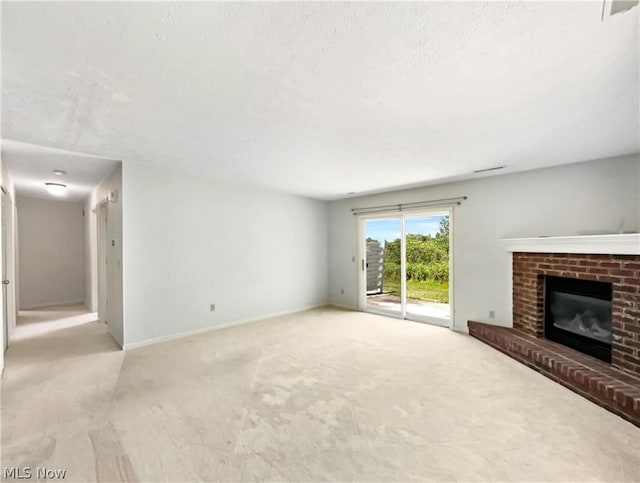 unfurnished living room with light carpet and a fireplace