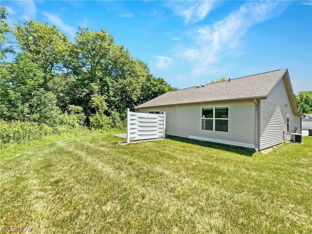 rear view of property with a yard