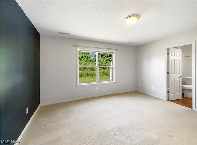 unfurnished room featuring light colored carpet