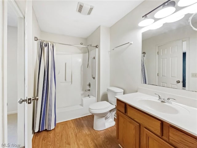 full bathroom with vanity, toilet, hardwood / wood-style floors, and shower / tub combo with curtain