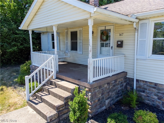 entrance to property featuring covered porch