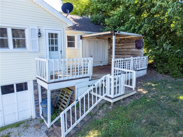 doorway to property featuring a wooden deck and a garage