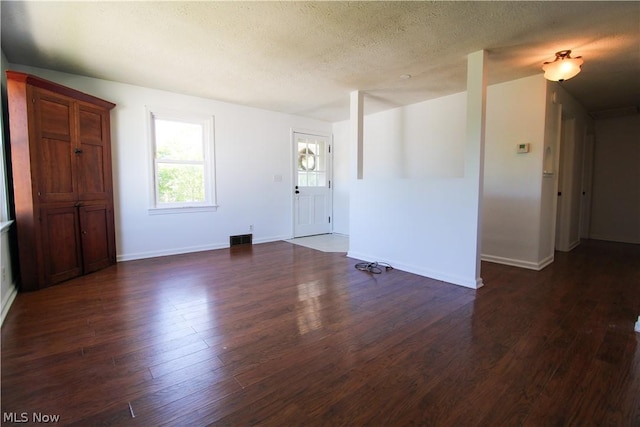 interior space featuring dark hardwood / wood-style floors and a textured ceiling