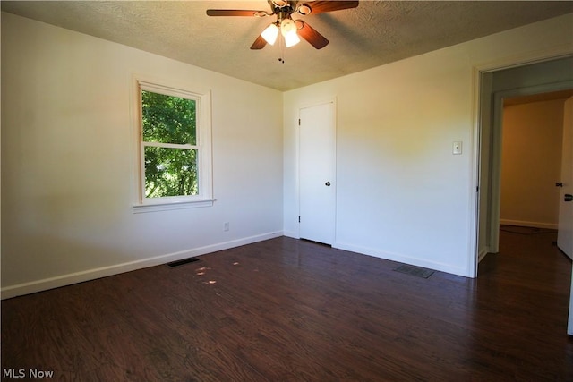 unfurnished bedroom with ceiling fan, dark hardwood / wood-style floors, and a textured ceiling