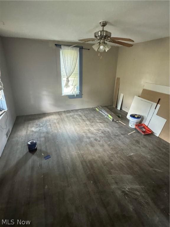 unfurnished living room with ceiling fan and wood-type flooring