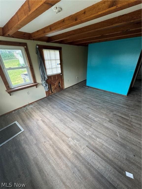 interior space with beamed ceiling and dark hardwood / wood-style flooring