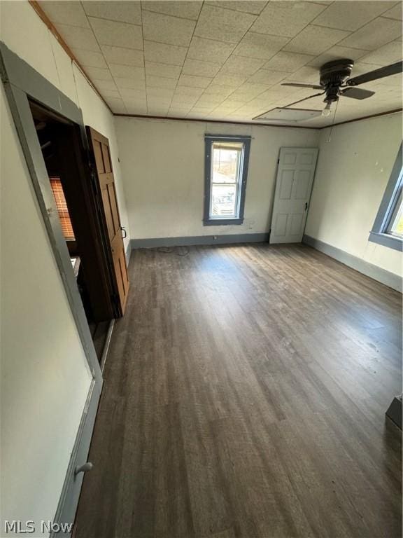 empty room featuring ceiling fan and dark wood-type flooring