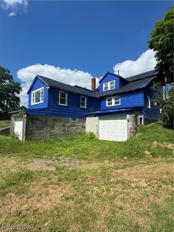 rear view of house with a garage