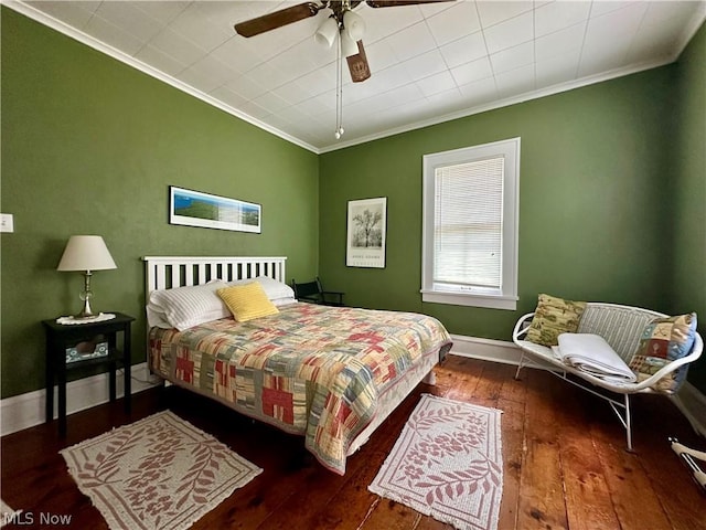 bedroom with ceiling fan, crown molding, and dark wood-type flooring