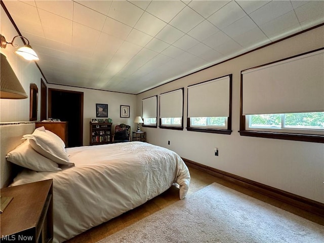 carpeted bedroom with crown molding