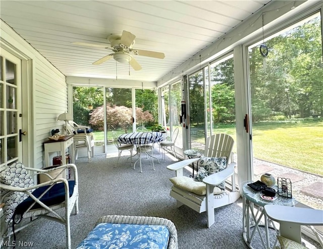 sunroom featuring ceiling fan