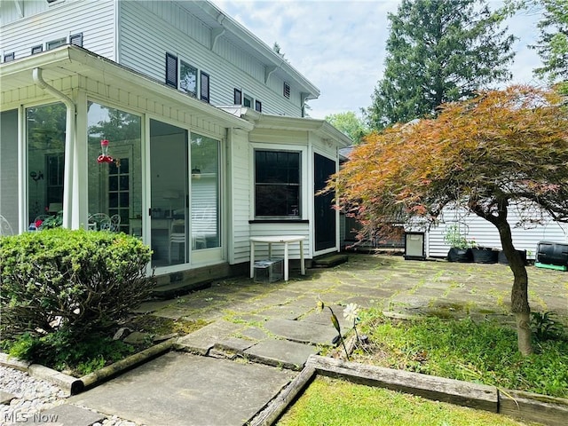 view of side of property featuring a patio area