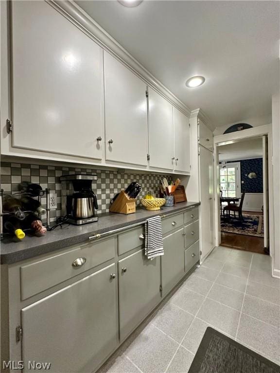 kitchen featuring light tile patterned floors and tasteful backsplash