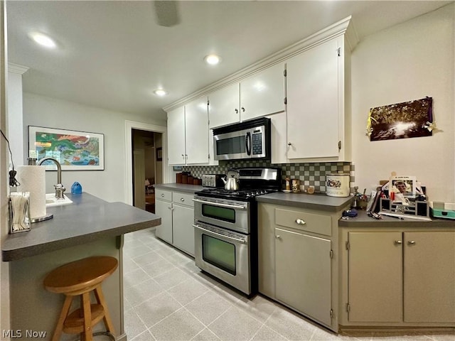 kitchen featuring decorative backsplash, light tile patterned flooring, and stainless steel appliances