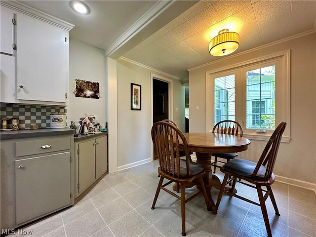 dining space featuring crown molding