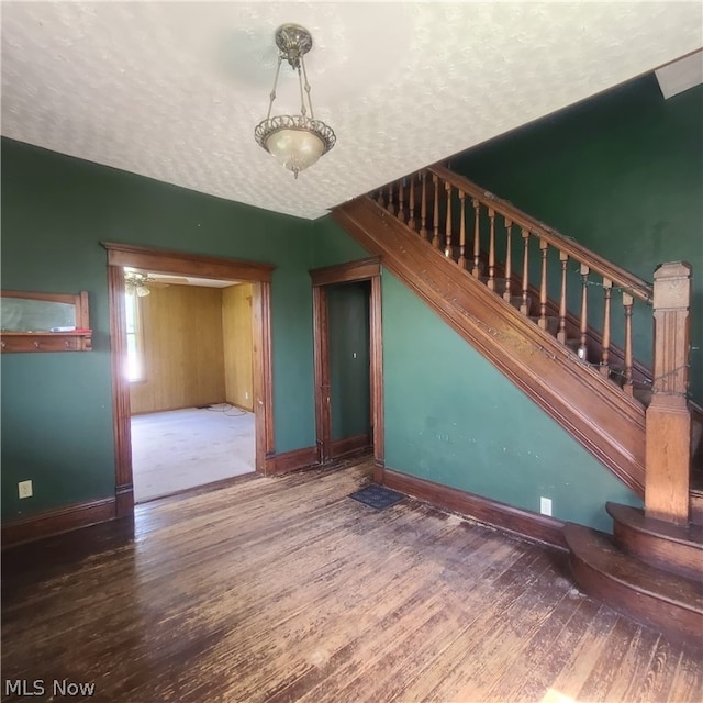 interior space with a textured ceiling and hardwood / wood-style flooring