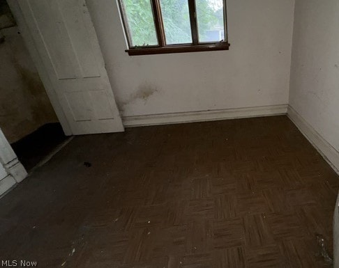 empty room with dark parquet floors