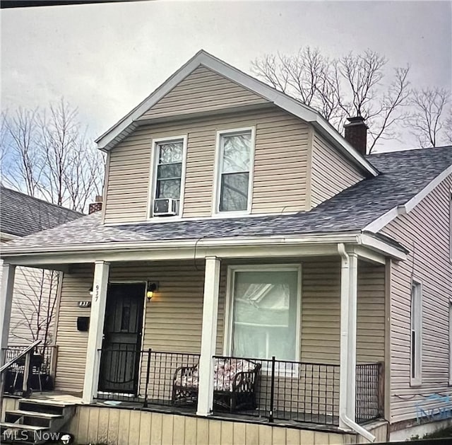 view of front of house featuring cooling unit and covered porch