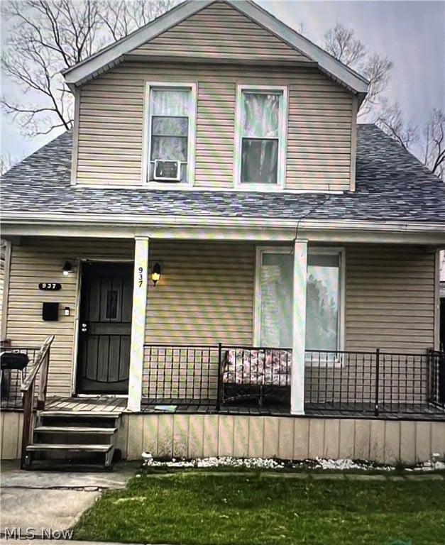 view of front of home with a porch and cooling unit