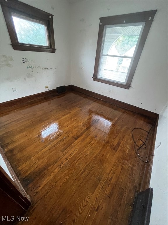 empty room with hardwood / wood-style floors