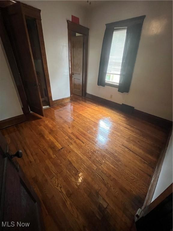 2936 E 128th St, Cleveland, OH 44120 - unfurnished bedroom featuring wood finished floors and baseboards