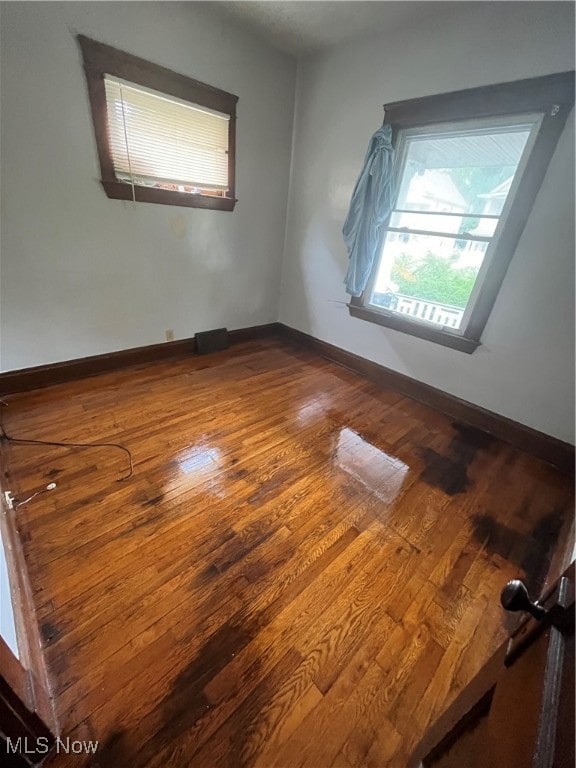 unfurnished room with hardwood / wood-style floors