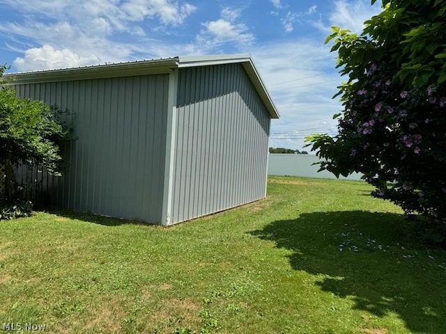 view of outbuilding with a lawn