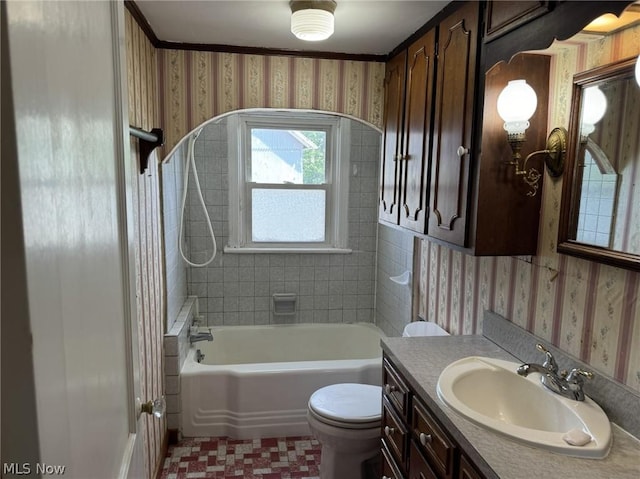 full bathroom with vanity, tiled shower / bath combo, and toilet